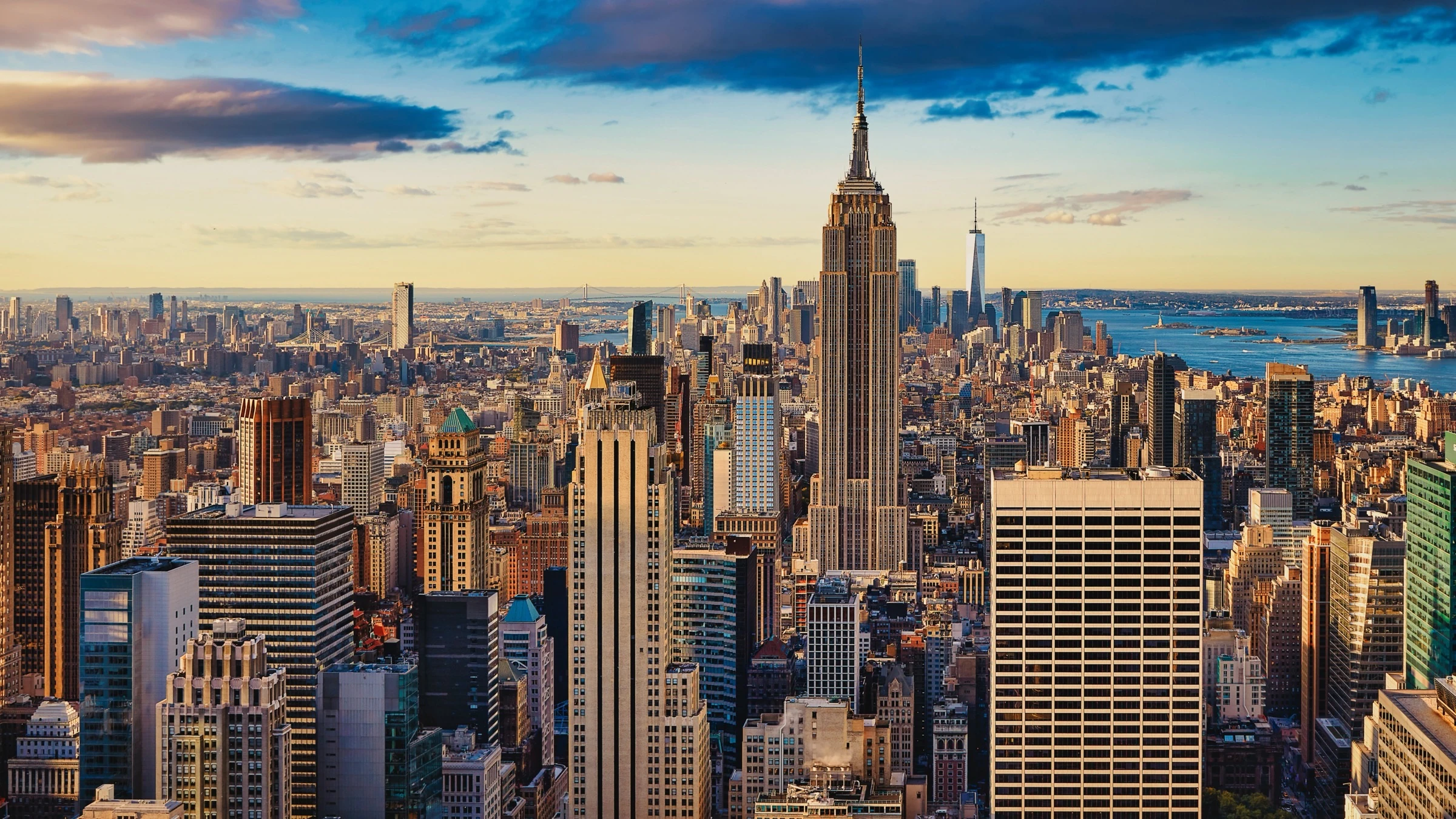 Skyline of New York with Empire State Building in Golden Evening Light, View from a Highrise
